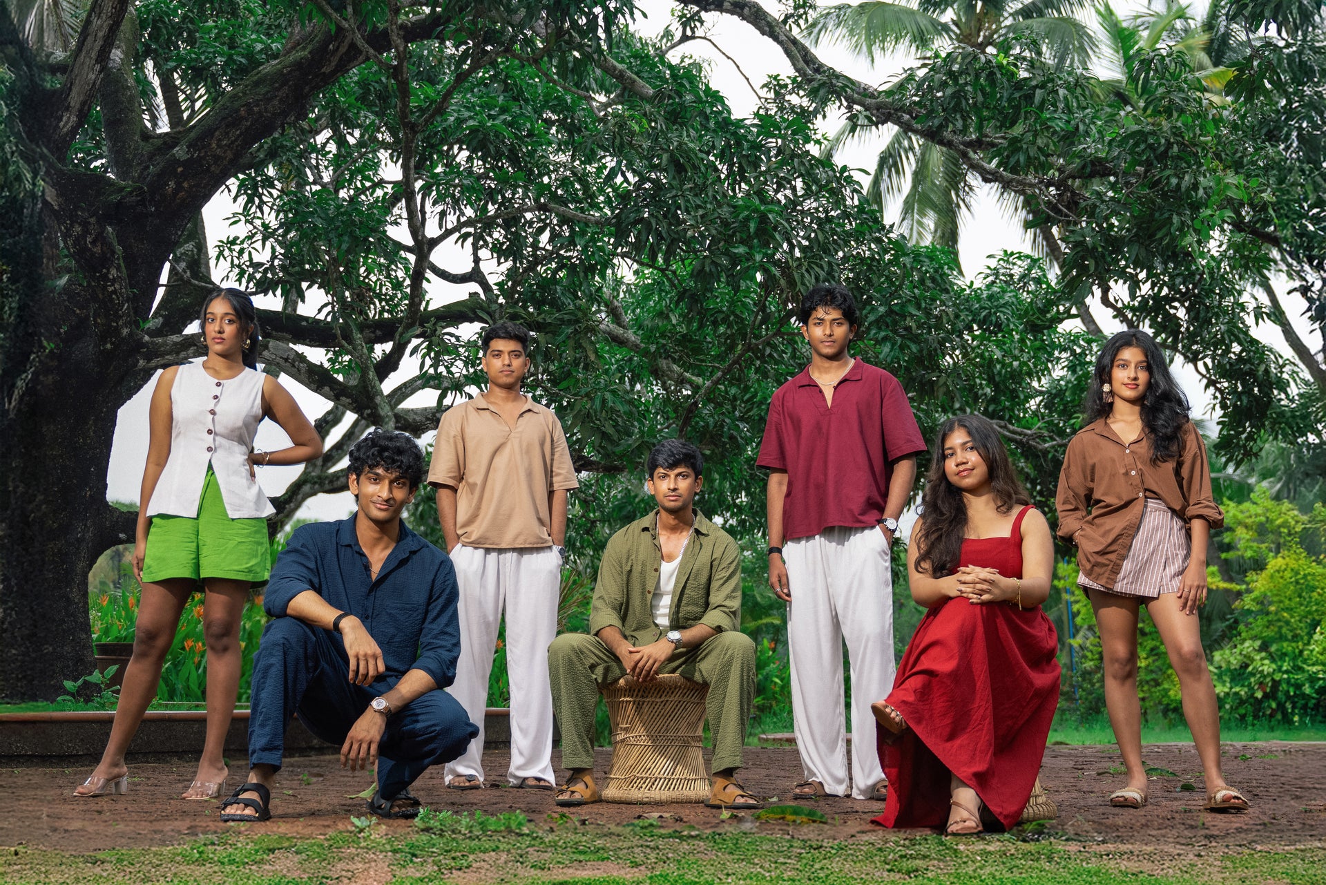 Group of people posing outdoors with trees in the background