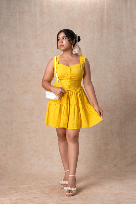 Woman wearing a yellow dress against a beige background